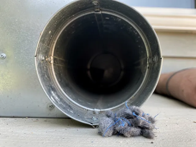 Montclair Dryer Vent Cleaning technician using specialized equipment to clear severe dryer vent blockage in Montclair